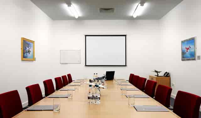 Comet Room at IWM Duxford, featuring a long table for professional meetings and presentations.