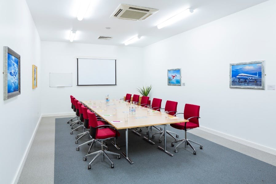 Comet Room at IWM Duxford: modern meeting space with red chairs for professional events.