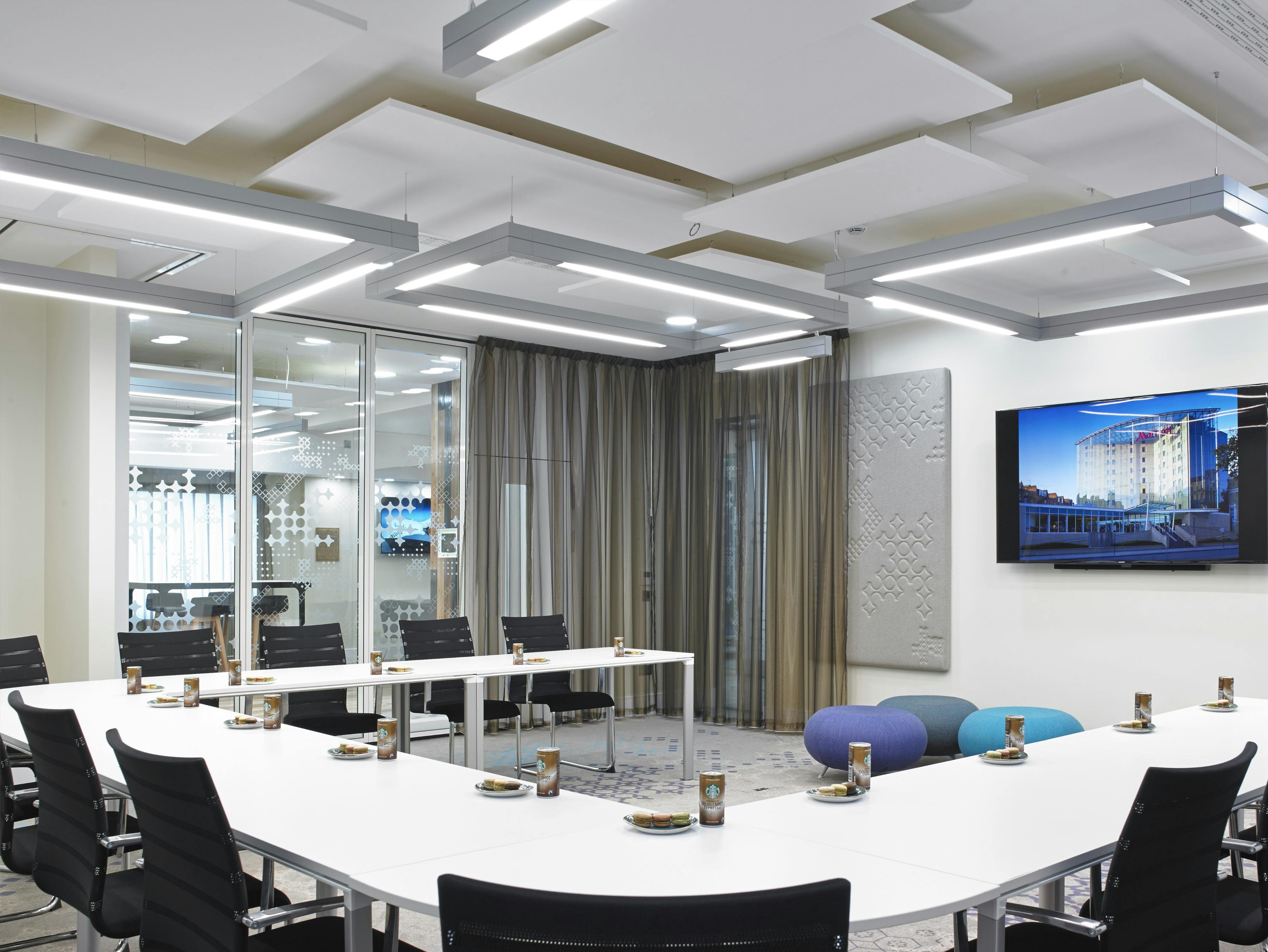 Modern meeting room at London Marriott Kensington with ergonomic chairs for collaboration.