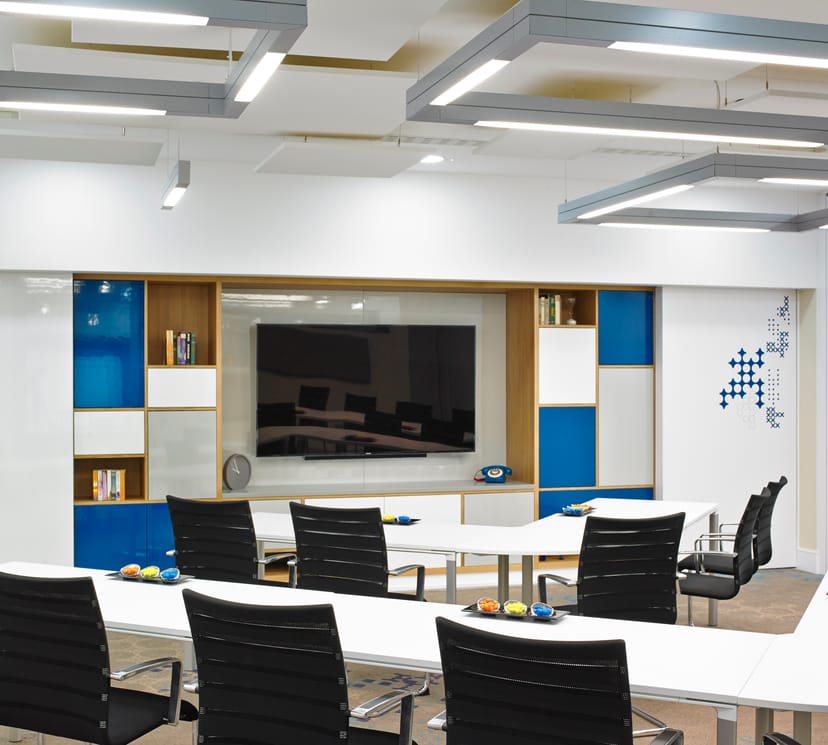 Modern meeting room at London Marriott Kensington with large screen and blue accents.