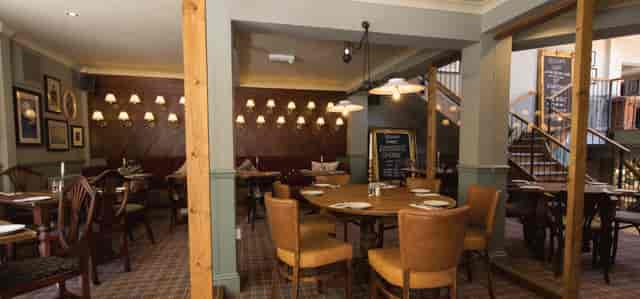 Main Cow Shed pub venue, intimate rustic interior for corporate events and social networking.