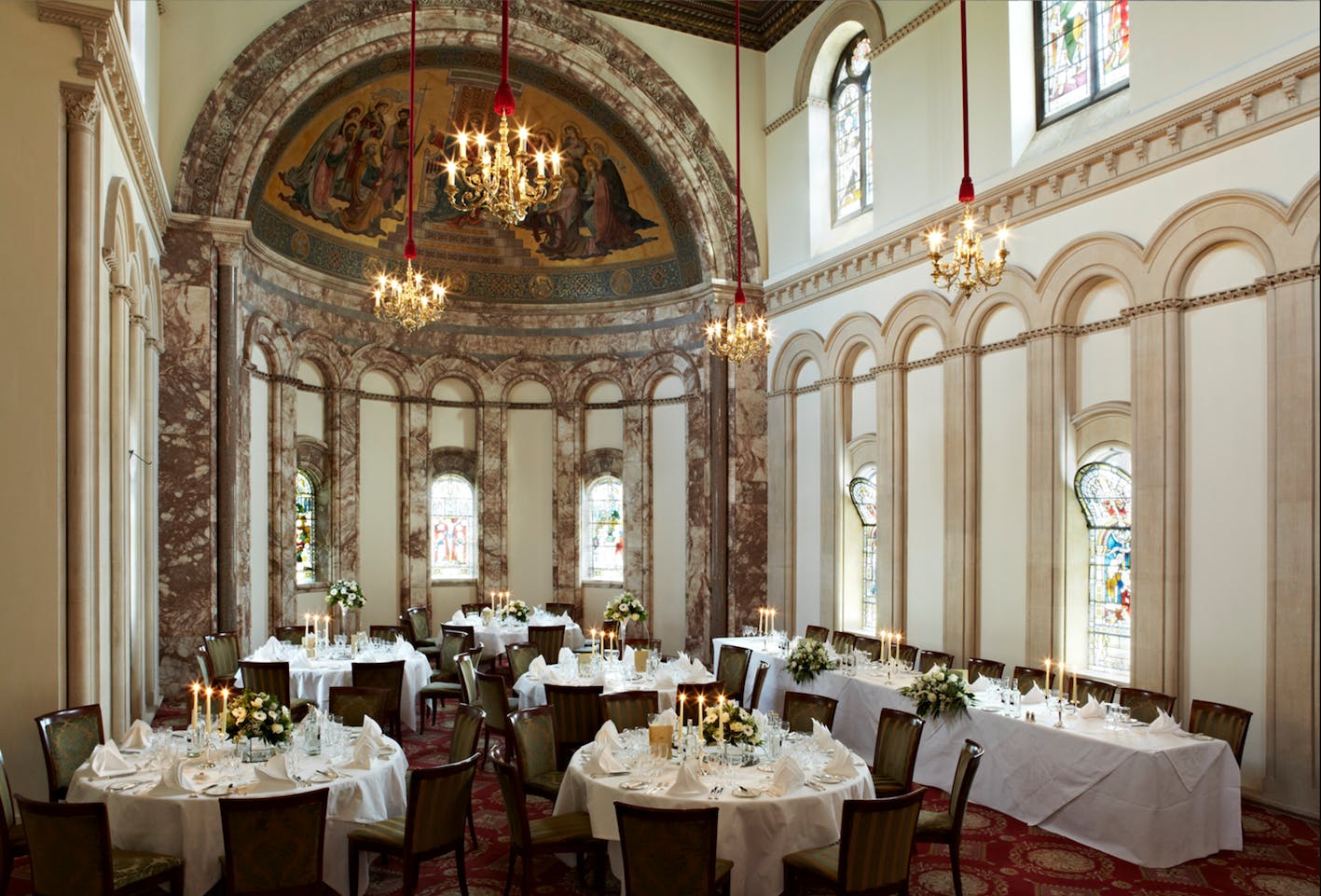 Elegant event space at Luton Hoo Hotel with floral centerpieces, perfect for weddings.