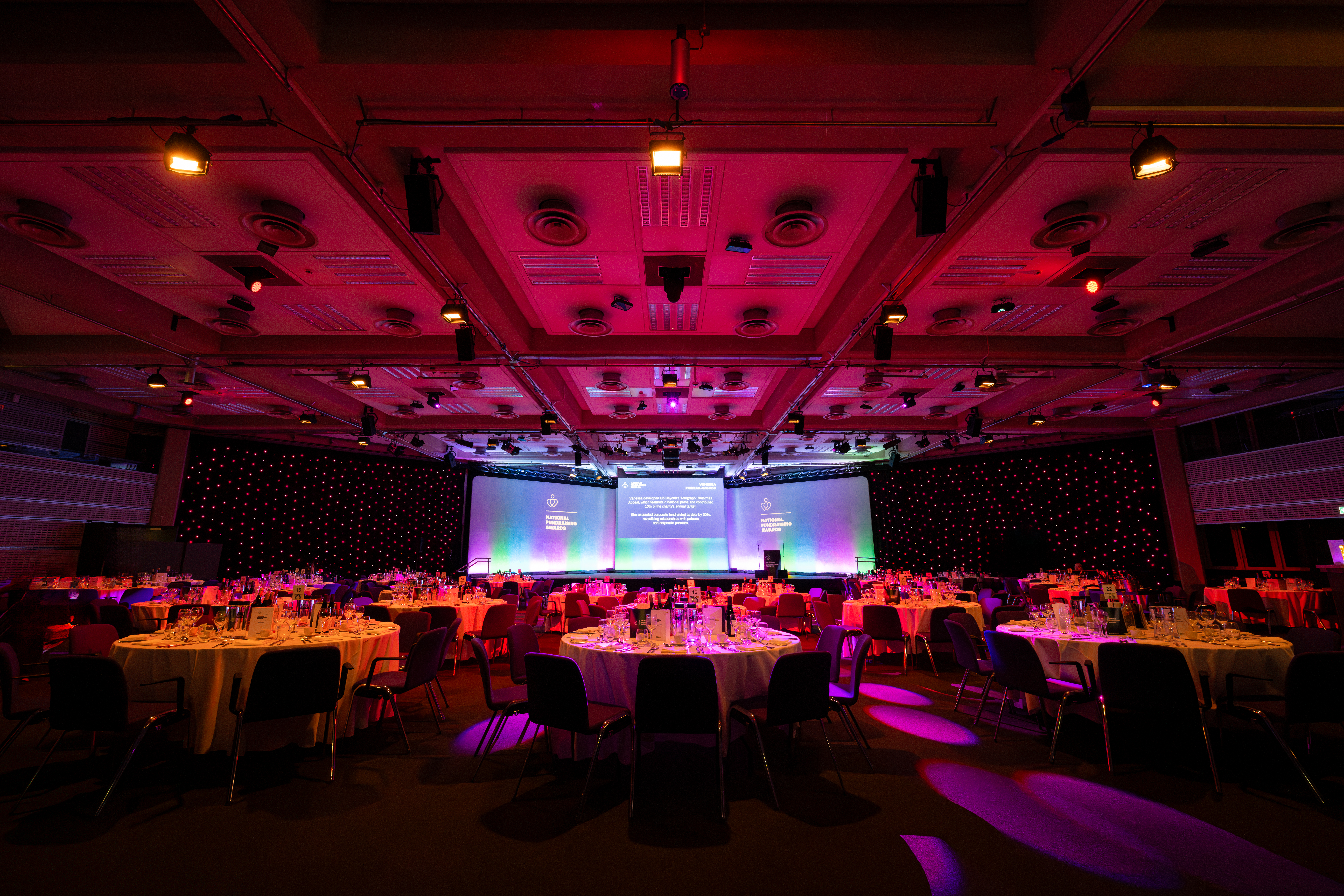 Elegant corporate event space with round tables at QEII Centre for banquets and galas. - Banner
