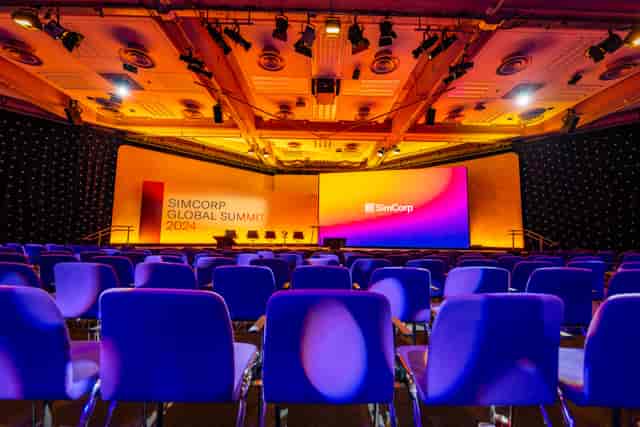 Conference setup at SimCorp Global Summit 2023 with vibrant branding and seating.
