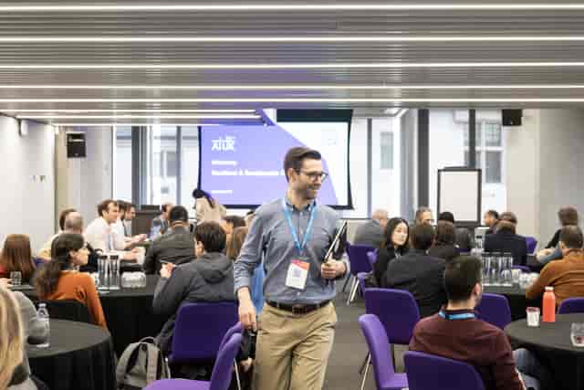 Gielgud at QEII Centre: modern conference with attendees networking at round tables.