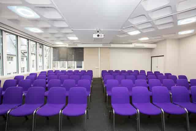 Albert in QEII Centre with purple chairs, perfect for workshops and presentations.