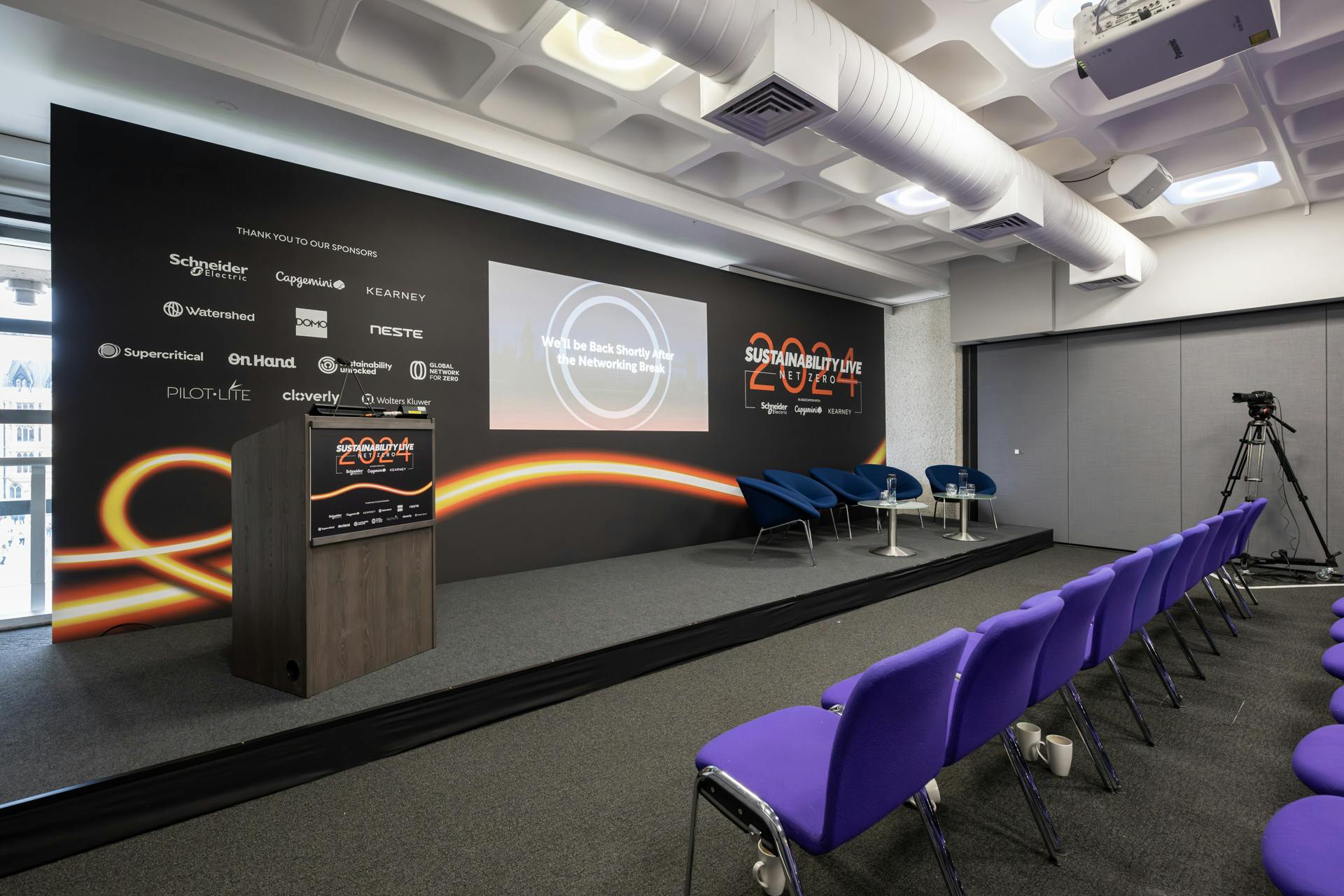 Event space at QEII Centre with sleek stage setup and modern seating for impactful meetings.