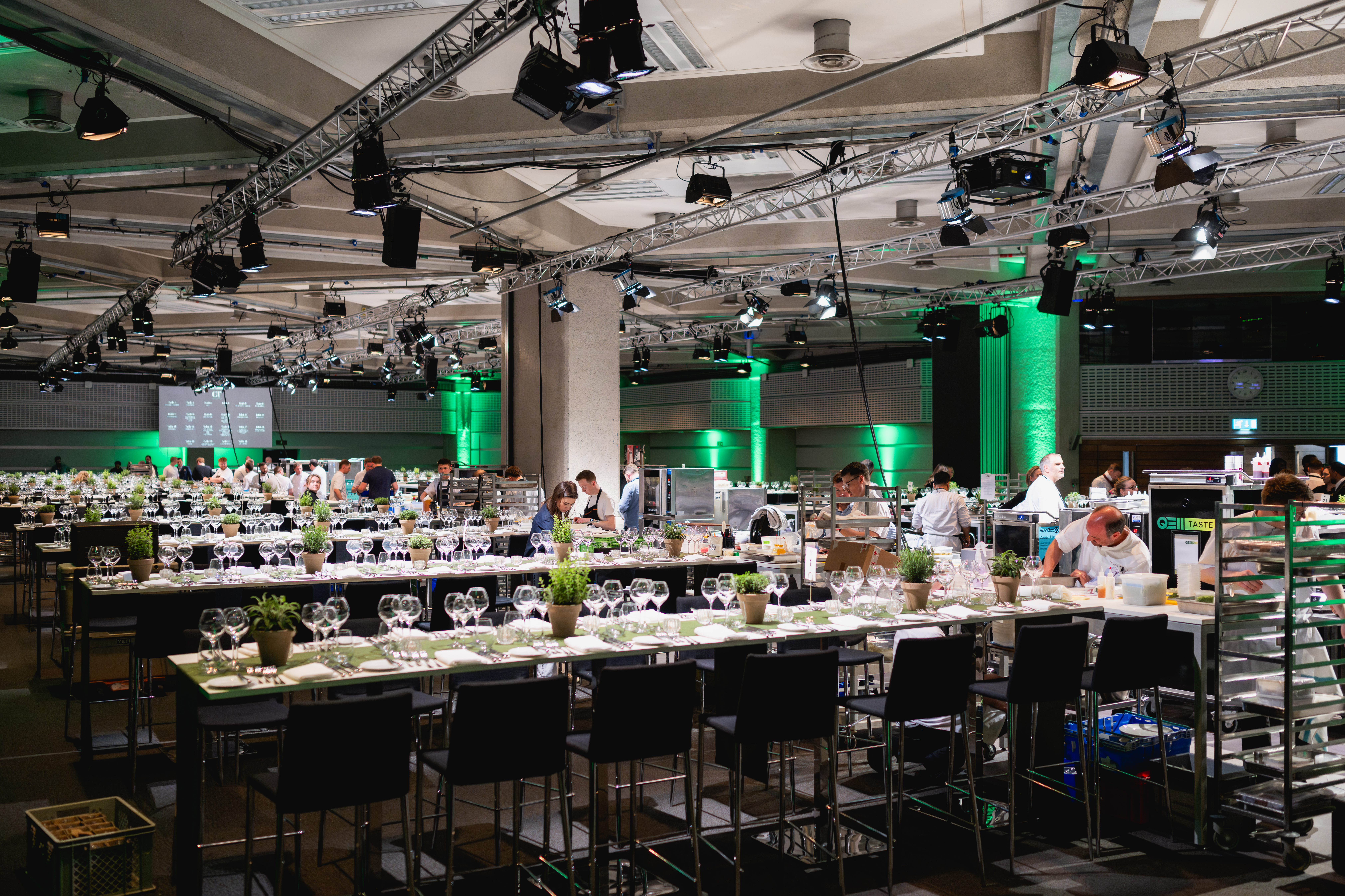 Elegant banquet setup with tables and greenery for corporate events at QEII Centre. - Banner