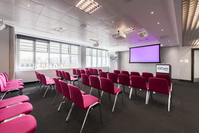 Abbey in QEII Centre meeting room with pink chairs, ideal for workshops and seminars.
