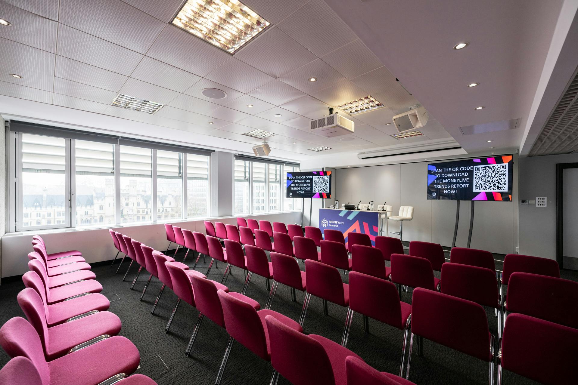 Abbey in QEII Centre: modern meeting space with dual screens for events and presentations.