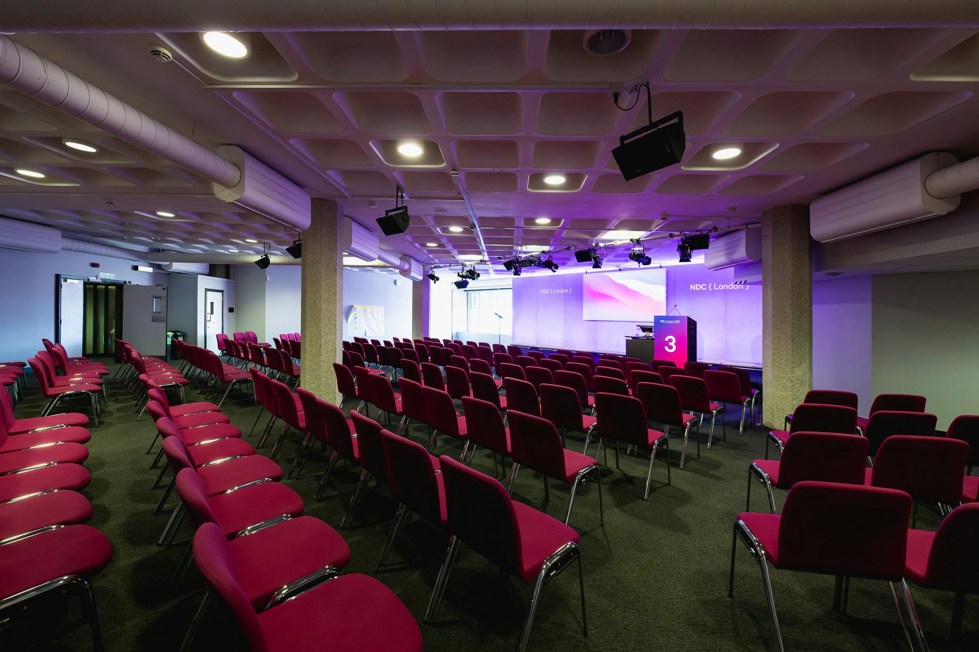 St James event space with vibrant pink chairs, ideal for conferences and presentations.