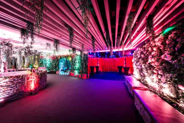 Vibrant event space in QEII Centre, featuring lush florals for social gatherings.