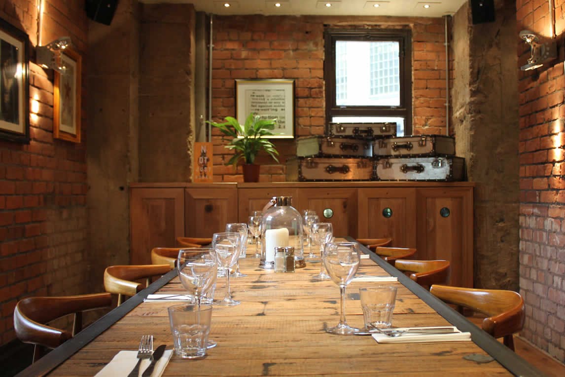 Intimate dining space with rustic decor for private events and meetings in Revolution Parsonage.