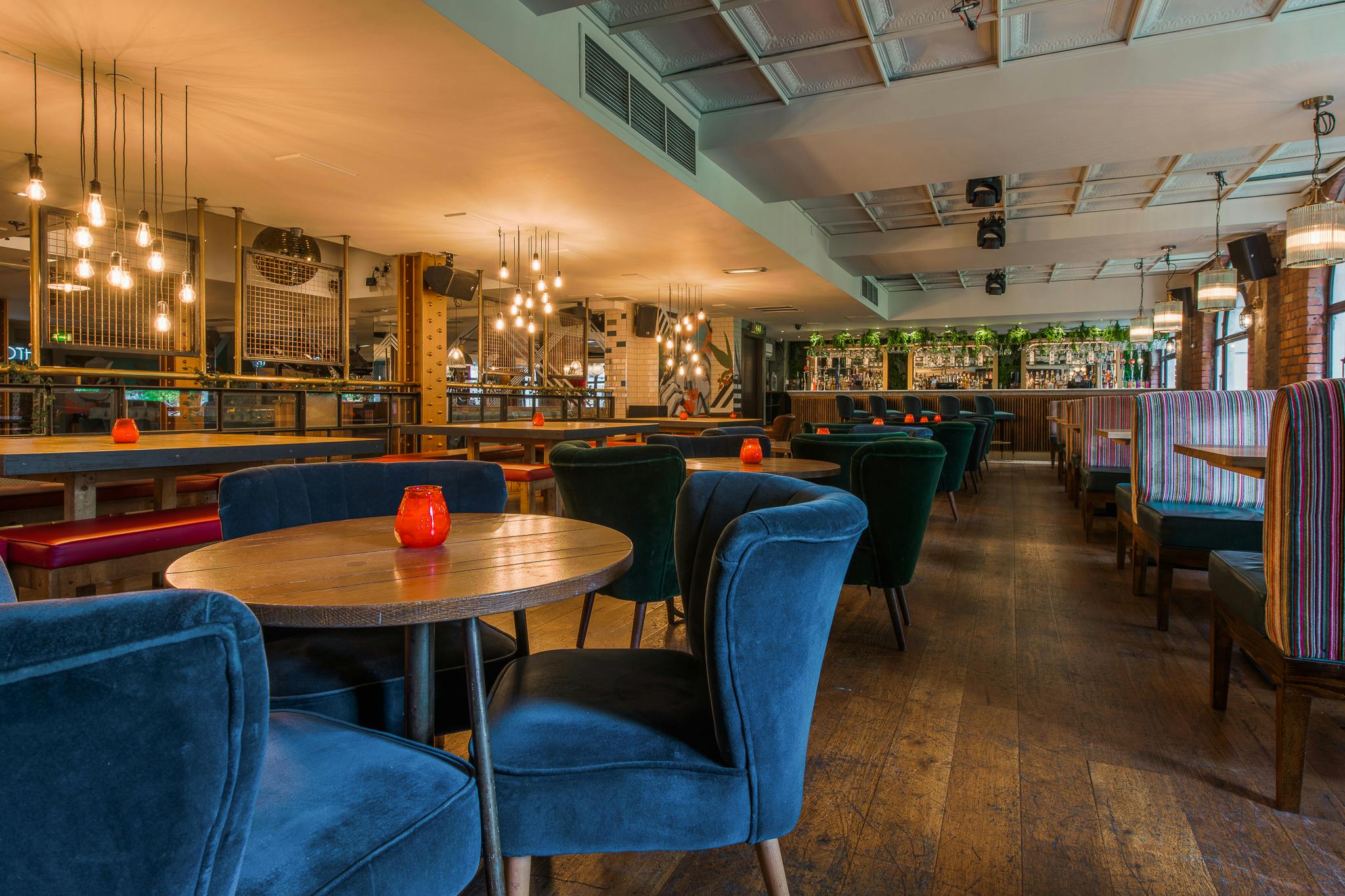 Modern event space with plush seating in The Garden Bar, perfect for networking and meetings.
