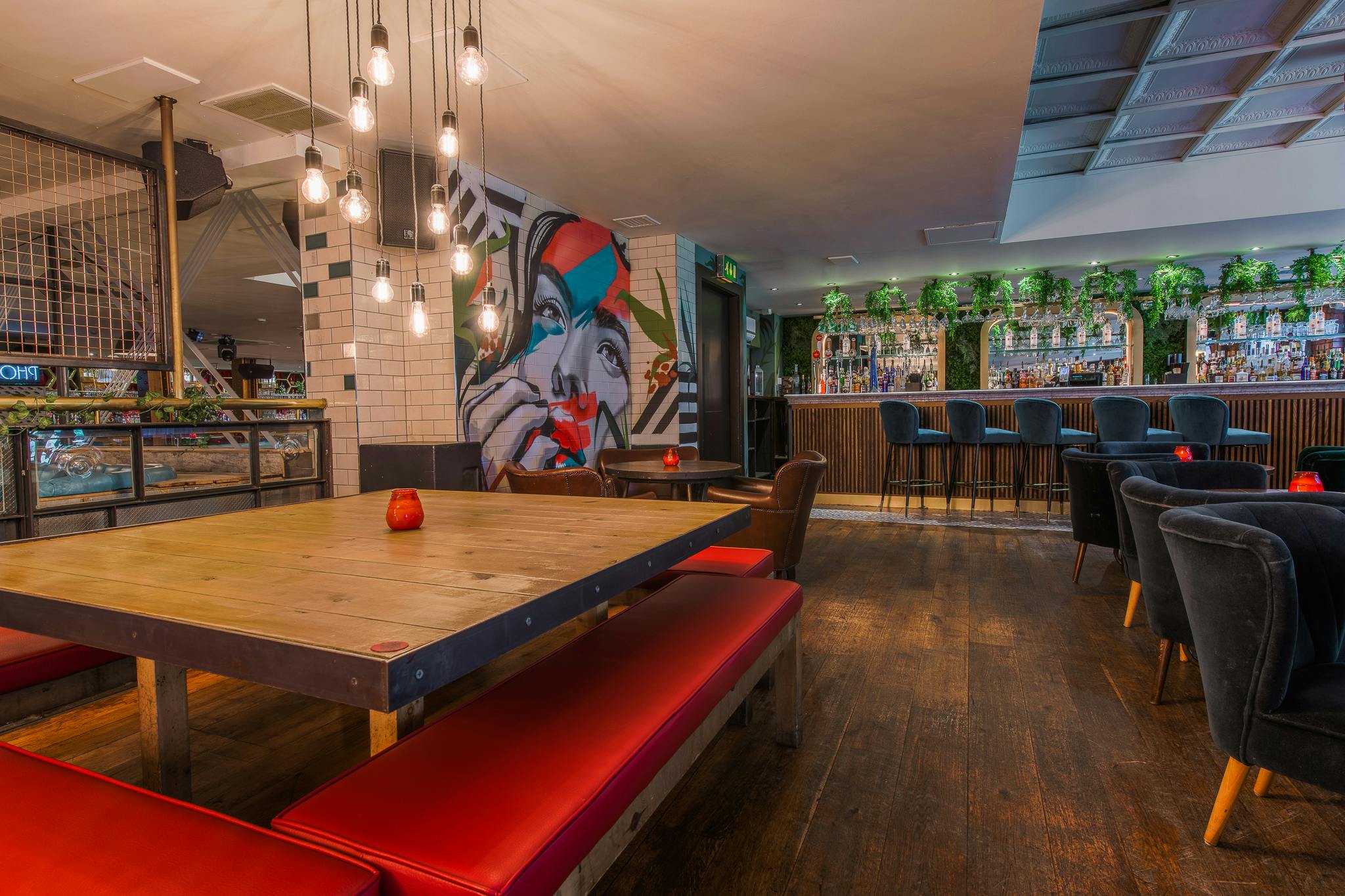 Stylish Garden Bar with vibrant mural, perfect for networking events and casual meetings.