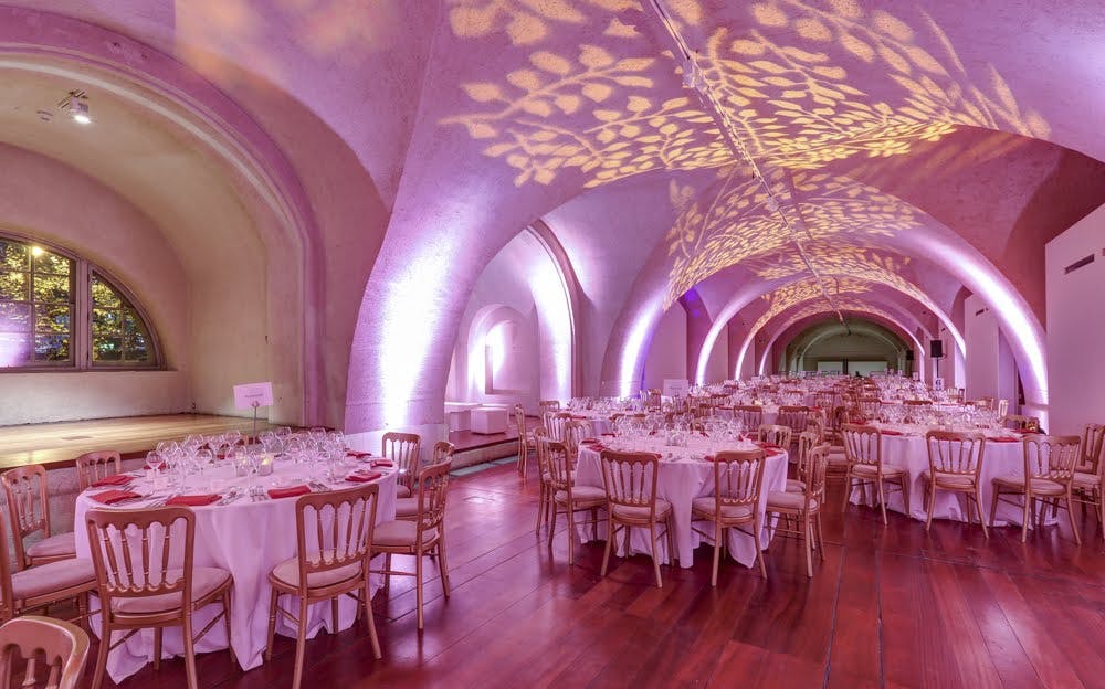 Elegant round tables set for a formal dinner in Somerset House event space.