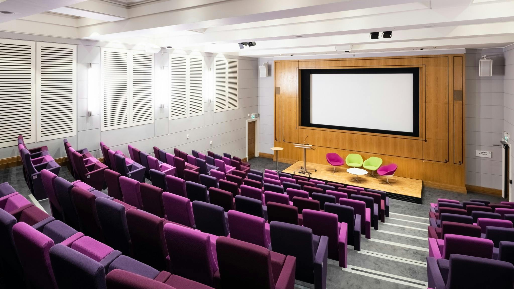 Henry Wellcome Auditorium with tiered purple seating for events and presentations.