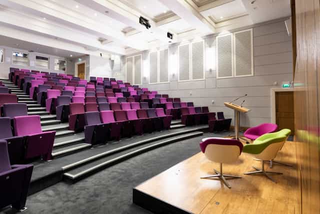 Henry Wellcome Auditorium with tiered purple seating for conferences and events.