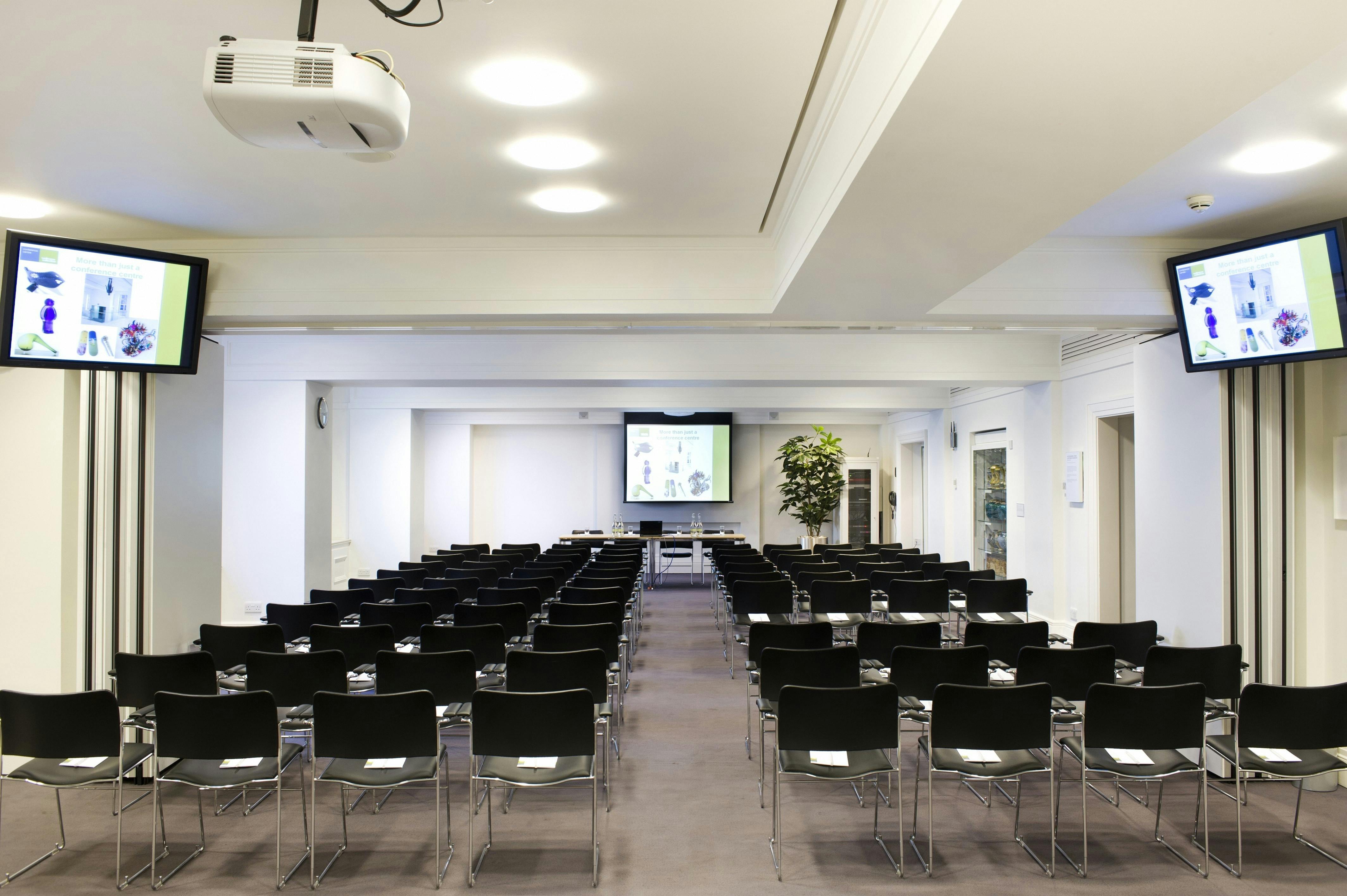 Franks & Steel Room: modern meeting space with black chairs for conferences and workshops.