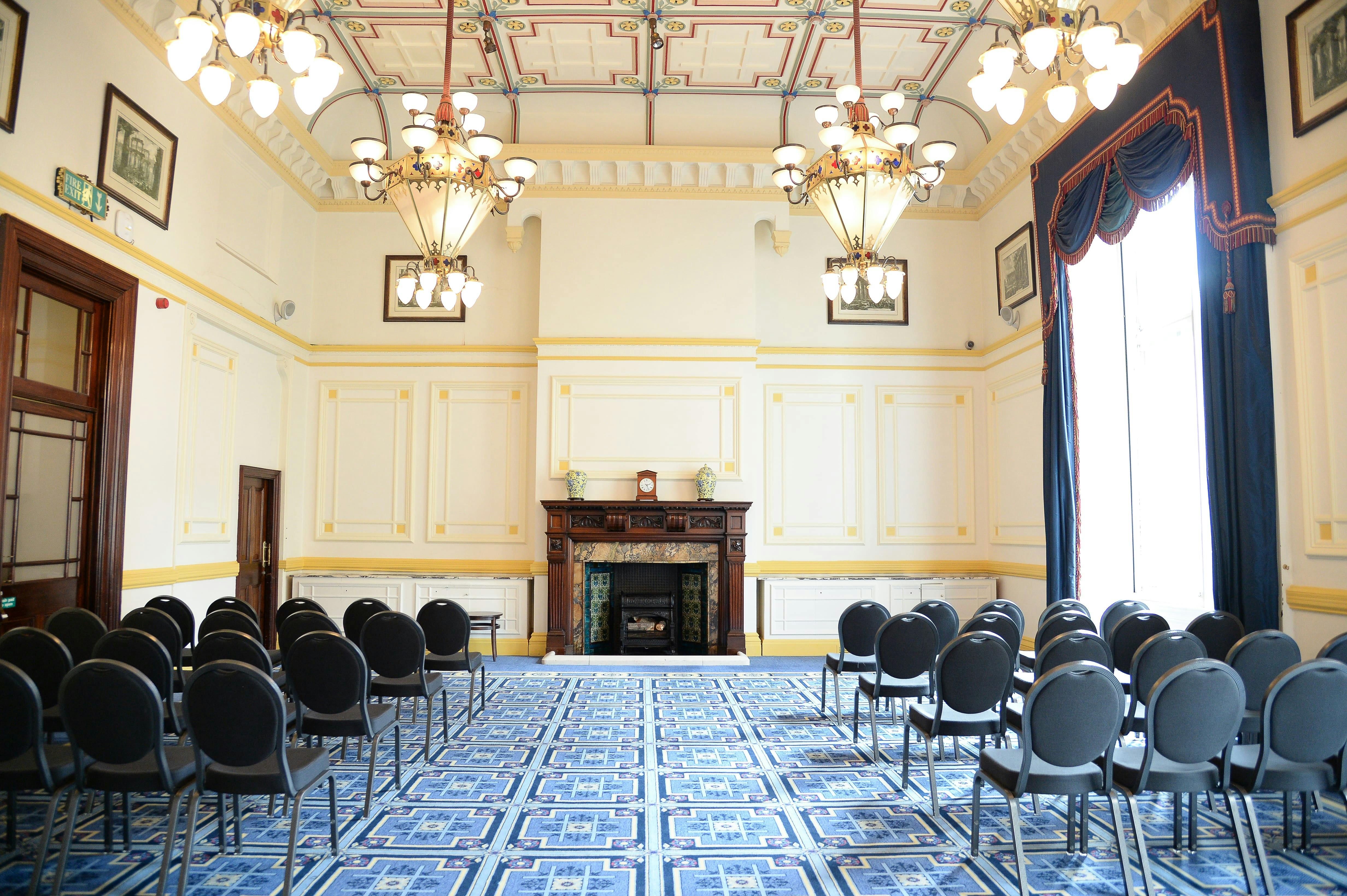 Meston Suite meeting room with chandeliers, ideal for presentations and networking events.