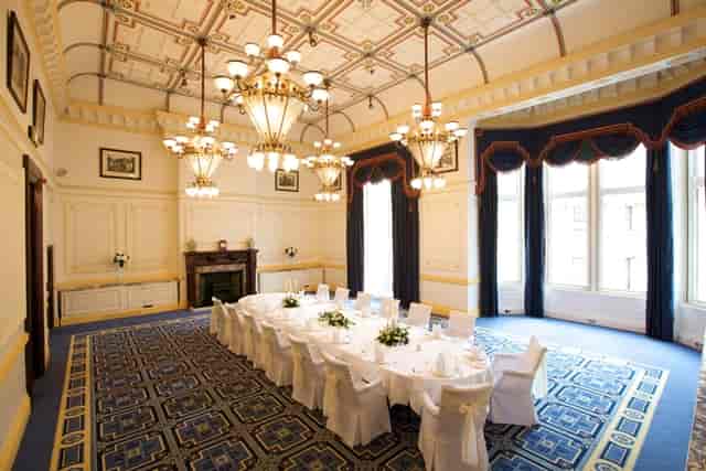 Meston Suite meeting room with floral centerpieces, ideal for corporate events and gatherings.