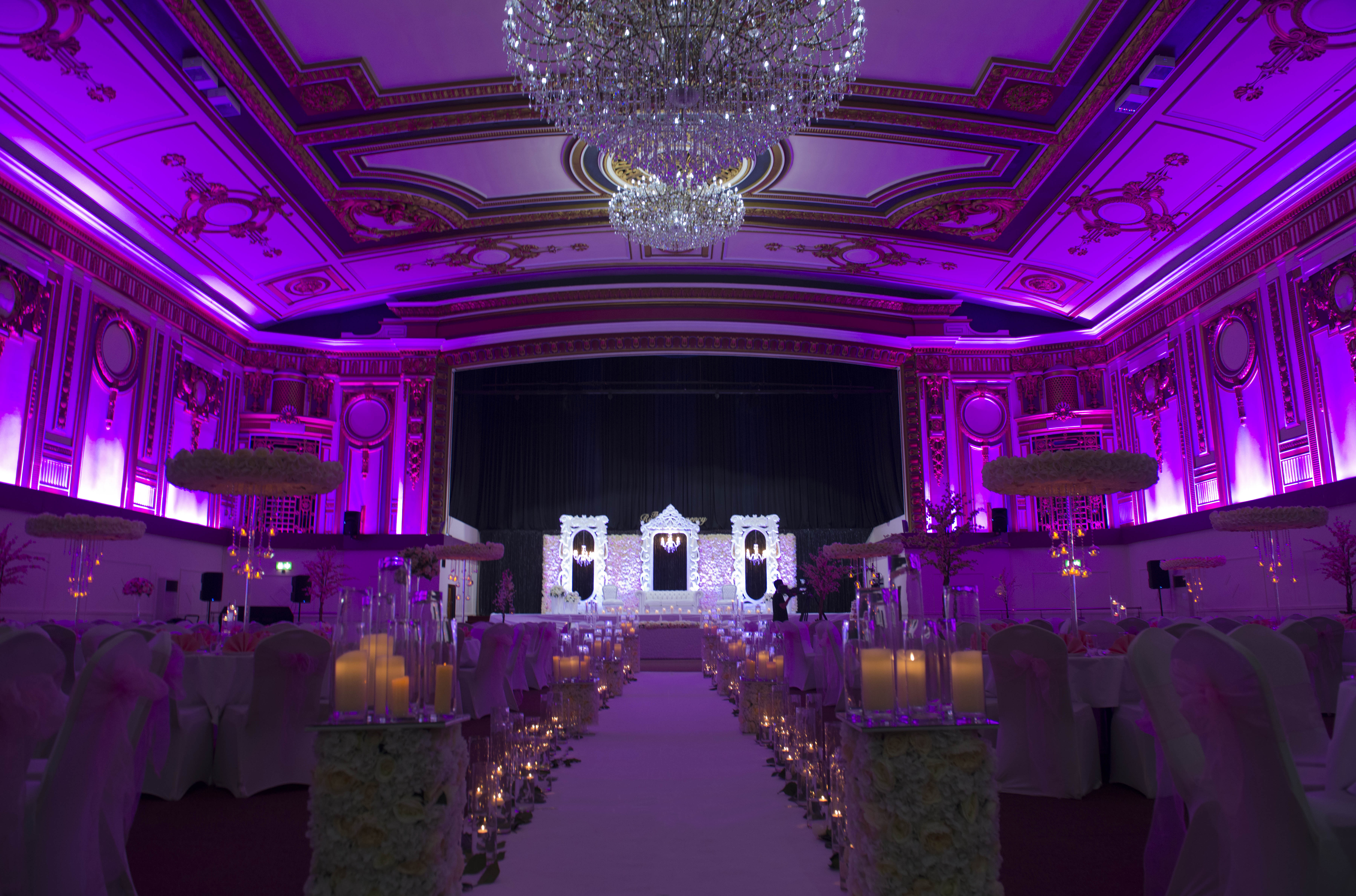 Grand Ballroom at The Royal Regency, elegant space for weddings and galas with purple lighting. - Banner