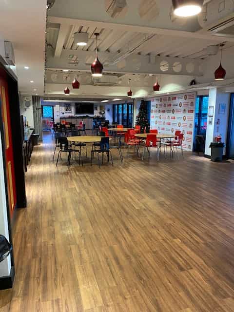 Versatile Function Room at FC United, featuring colorful chairs for meetings and events.