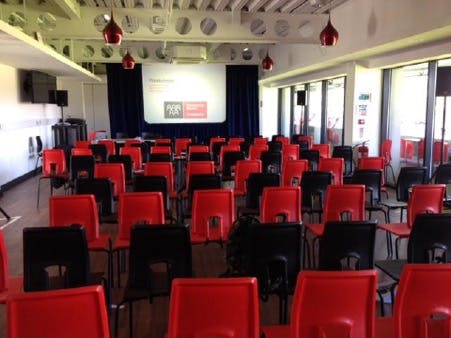 Function Room at FC United: red and black chairs for presentations and seminars.