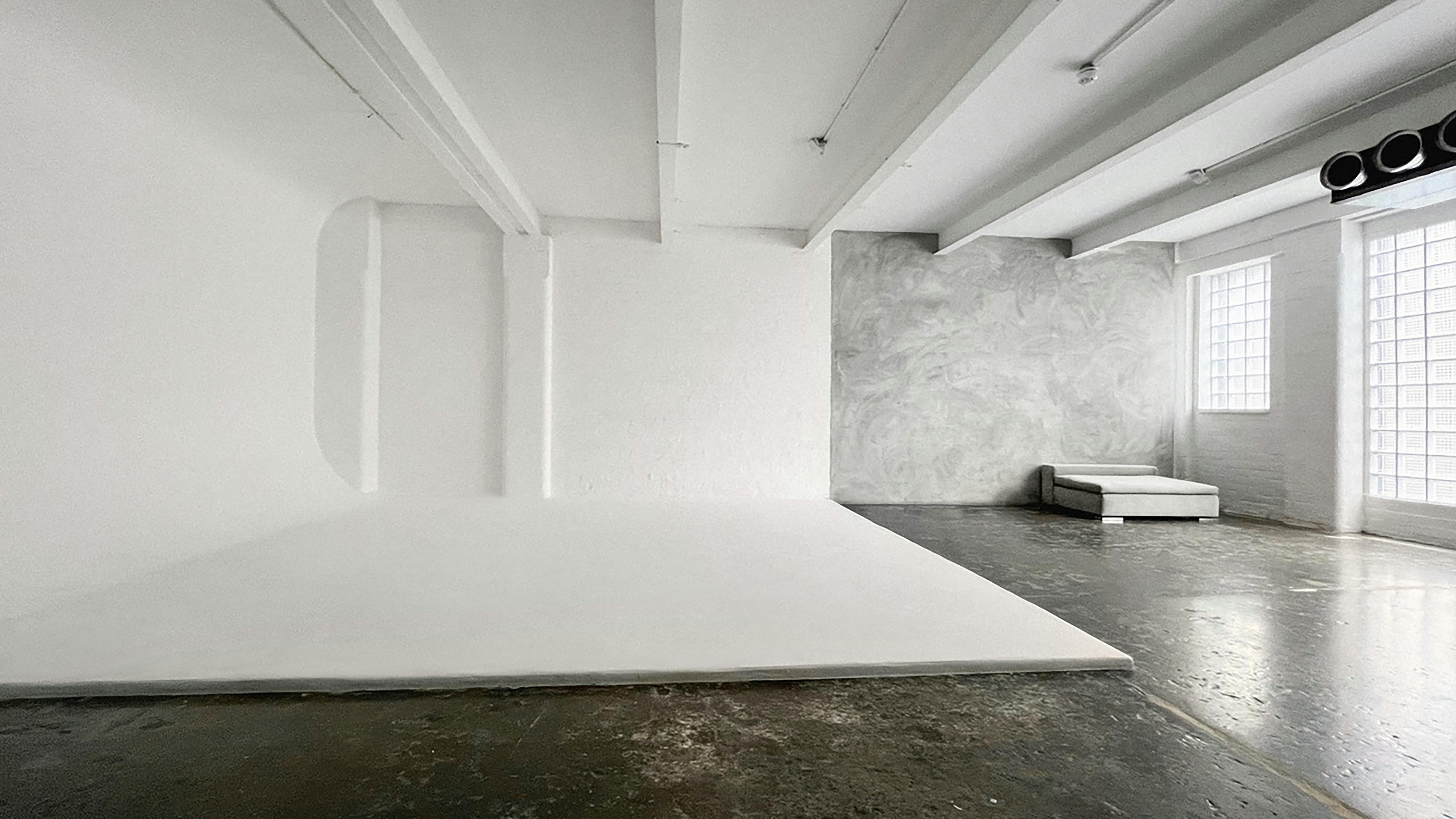 Versatile minimalist event space with natural light for workshops and product launches.