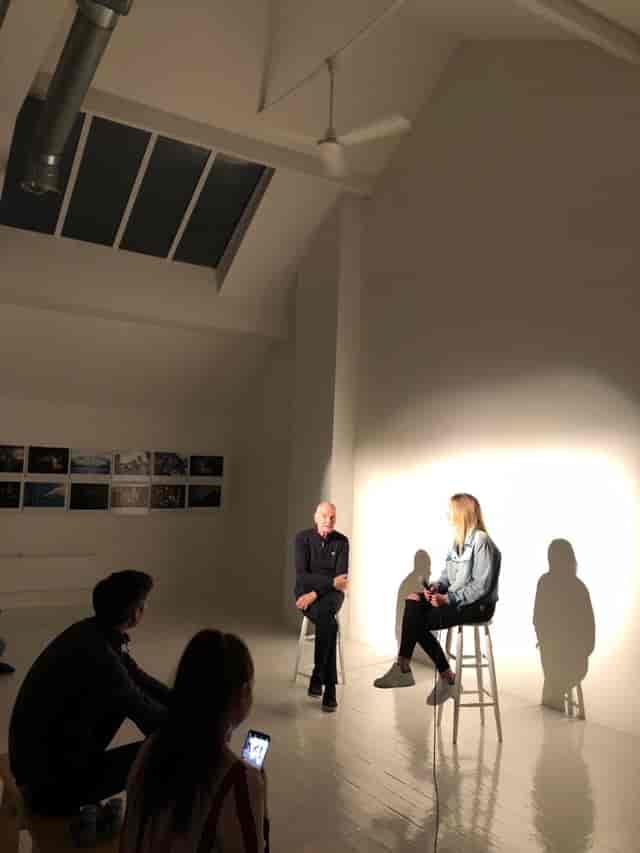 Loft panel discussion setup with speakers in minimalist space for engaging events.