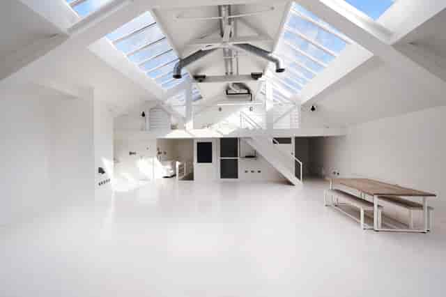 Bright loft venue with high ceilings for corporate events and creative workshops.