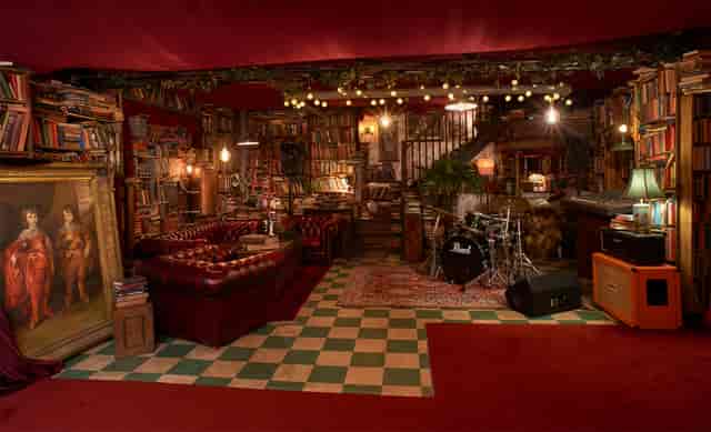 Cozy eclectic event space with warm lighting, perfect for gatherings and performances.