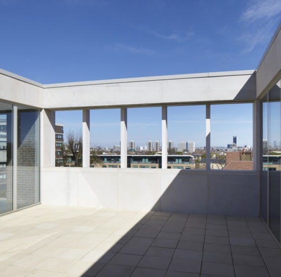 Modern event space with large windows at Beguine Terrace, ideal for corporate meetings.