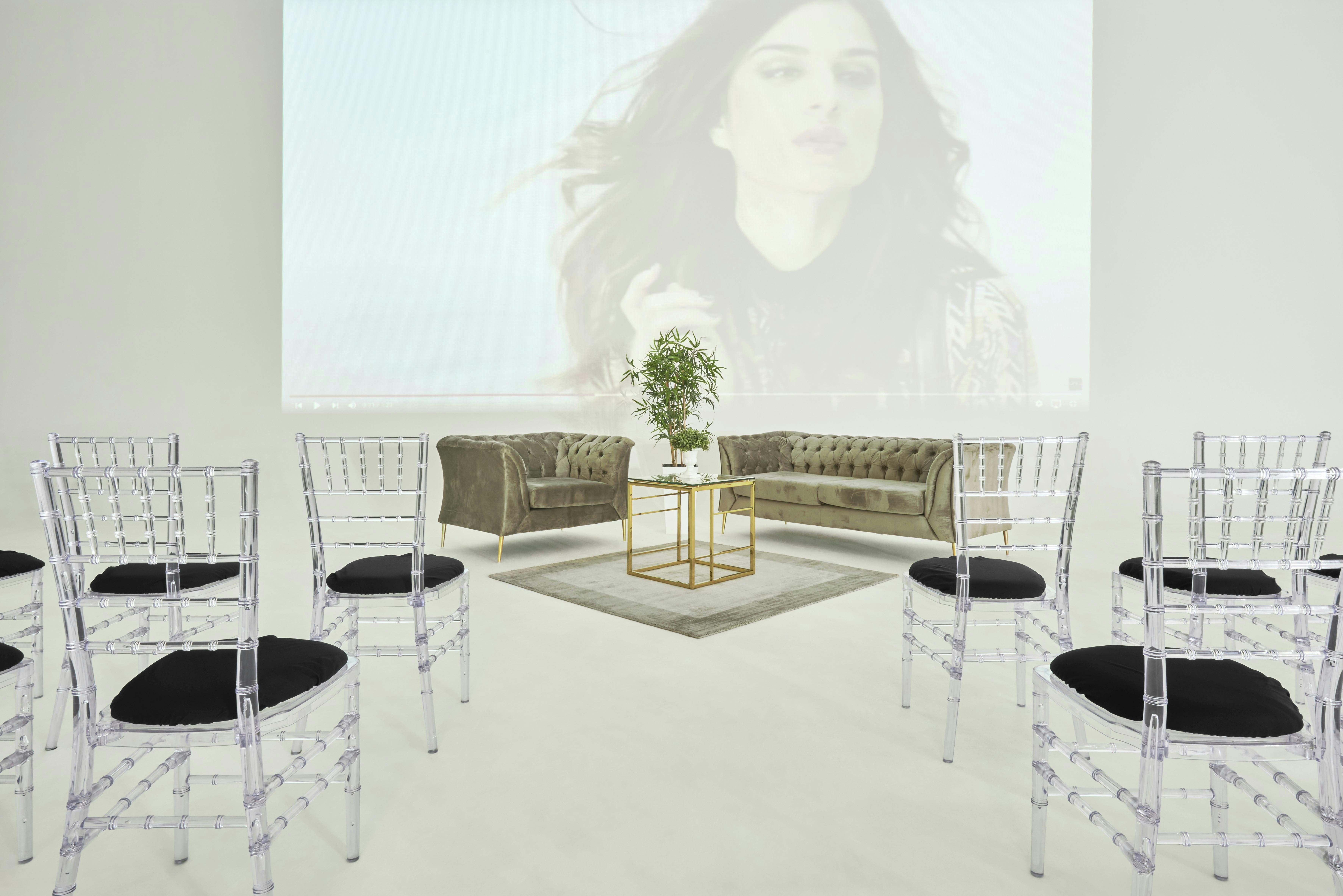 Sleek event space with acrylic chairs, ideal for workshops and networking events.