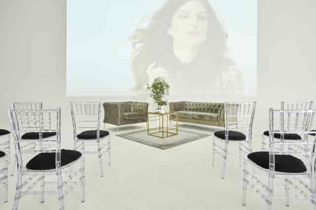 Sleek event space with acrylic chairs, ideal for workshops and networking events.
