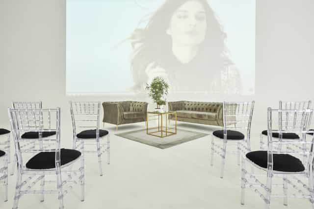 Sleek event space with acrylic chairs, ideal for workshops and networking events.