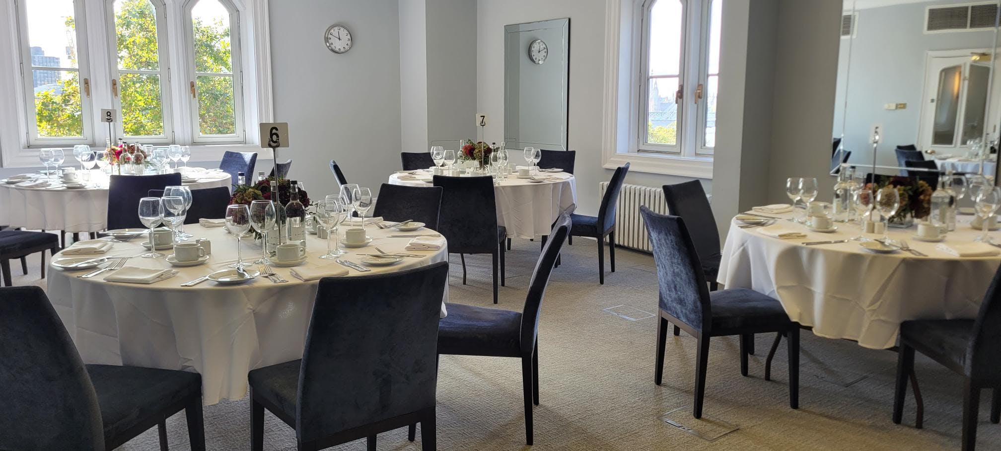 Trafalgar Room in Arundel House, elegant event space with round tables for meetings and dinners.