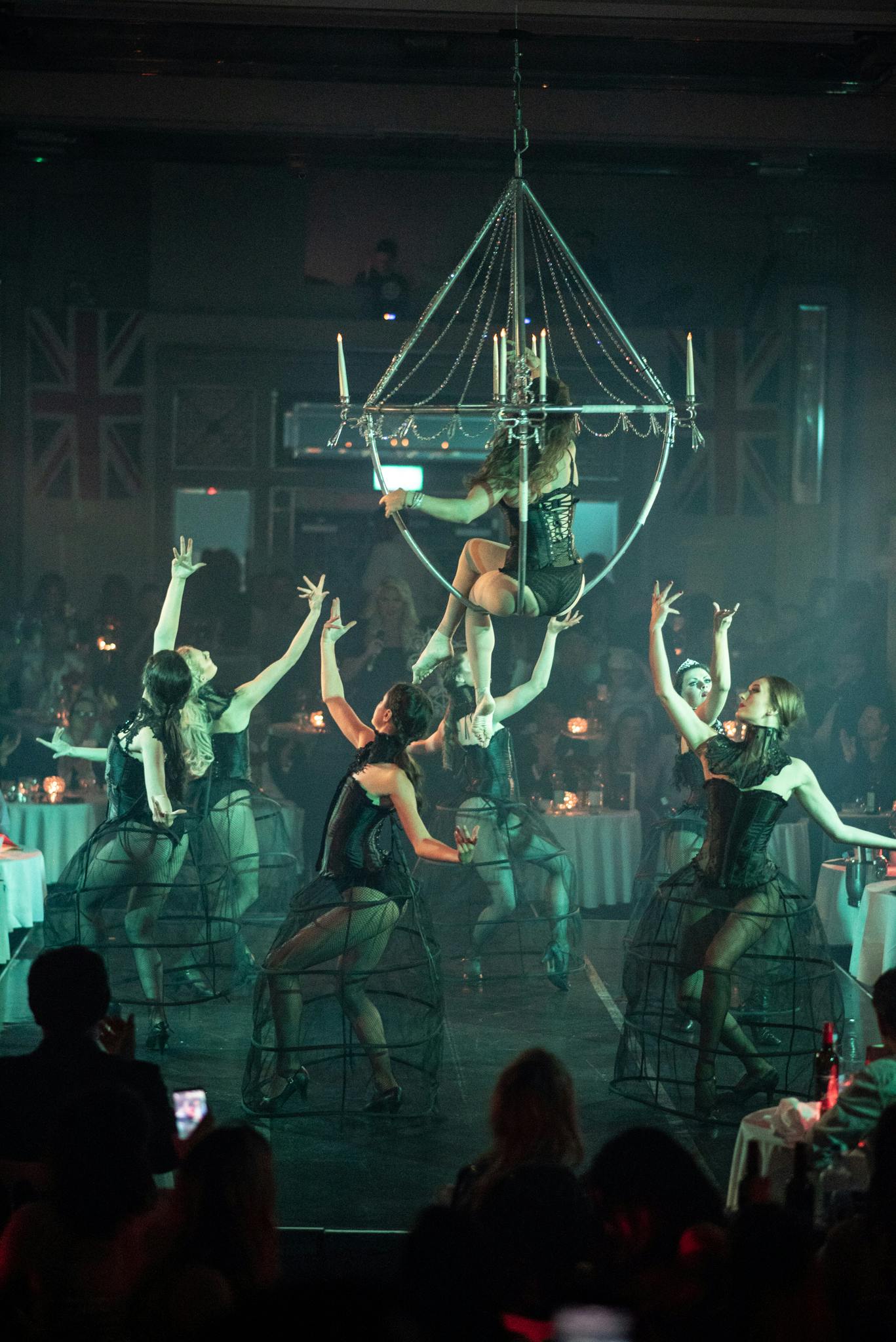 Aerialists perform at London Cabaret Club in elegant attire, enhancing upscale events.