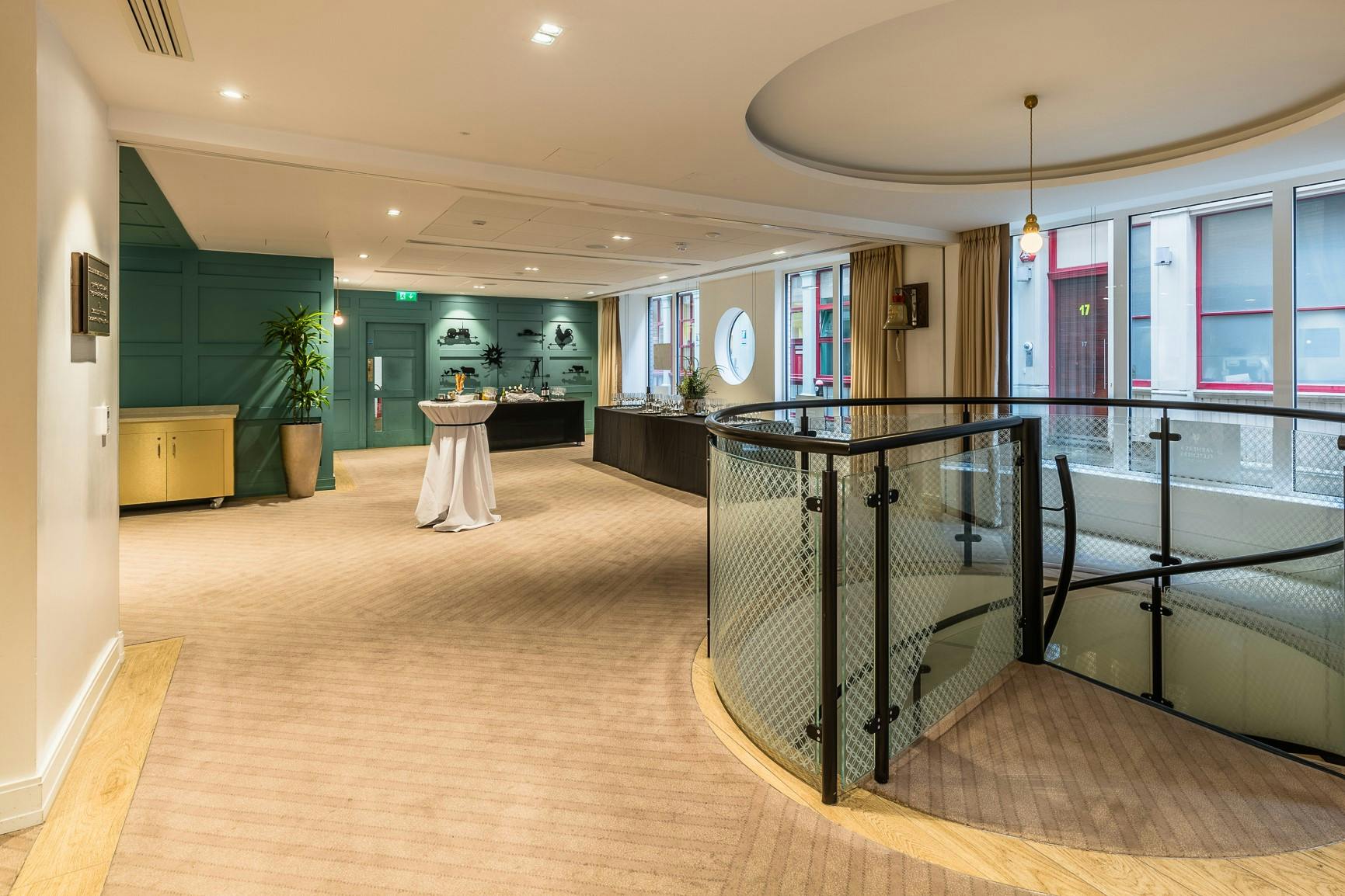 Elegant reception room with circular staircase, perfect for networking events and receptions.