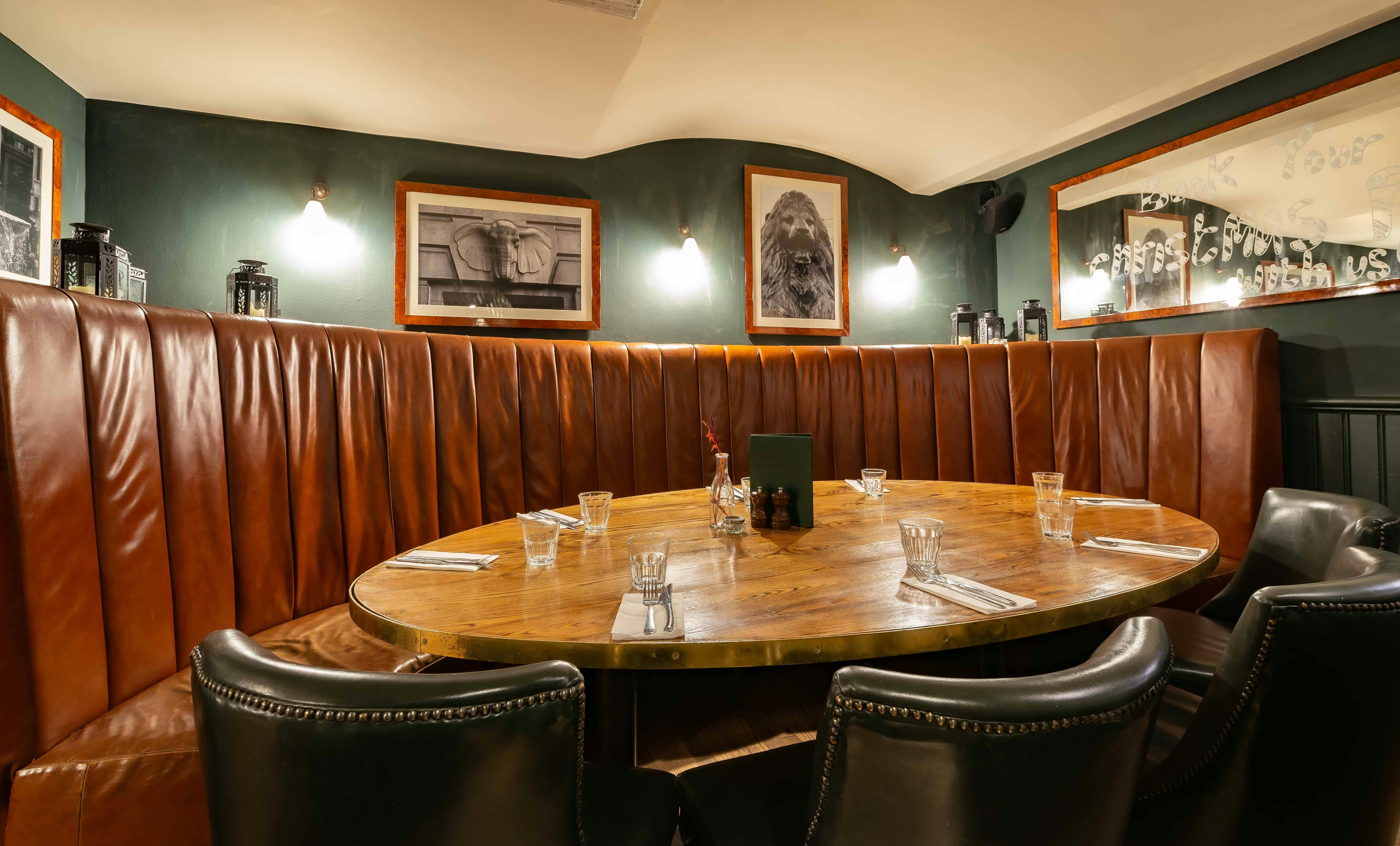 Trafalgar Room dining space with plush leather seating for private events and meetings.