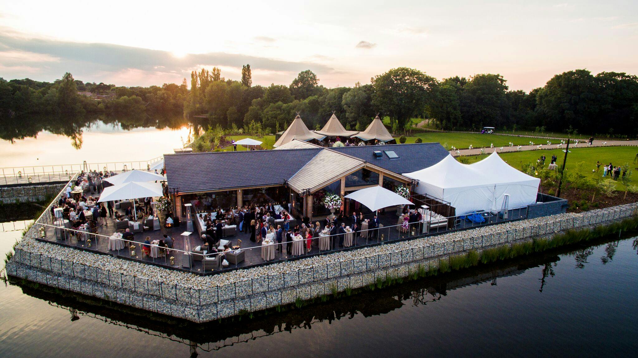 Outdoor event venue at Amber Lakes with spacious deck and elegant tents for weddings.