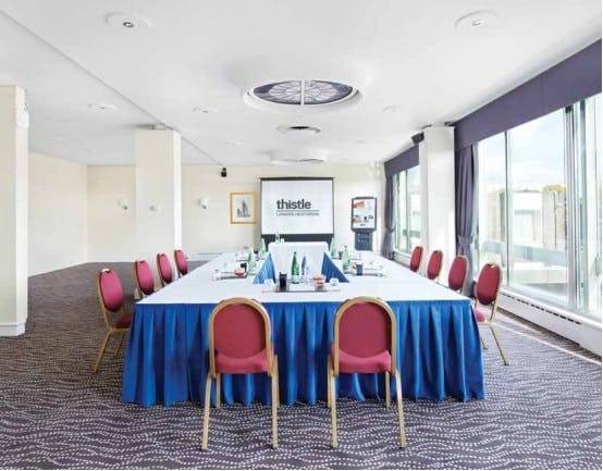 Meeting room in Thistle London Heathrow with elegant blue tablecloth for professional events.