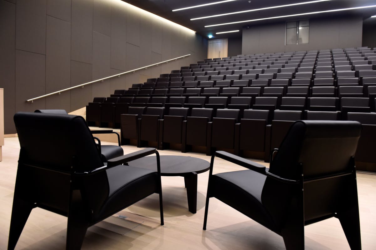 Bakala Auditorium with sleek black seating for presentations and lectures at Design Museum.