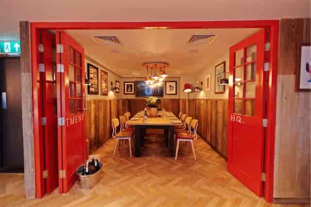 Vibrant meeting space with bold red doors, ideal for creative gatherings and brainstorming.