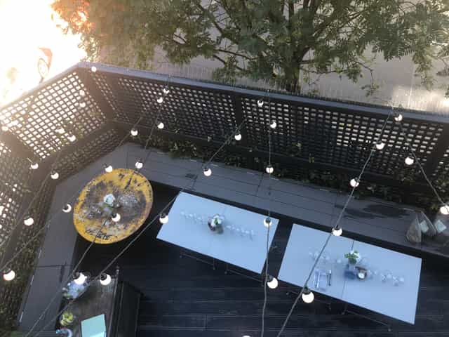 Outdoor event space at Martello Hall with floral centerpieces and string lights.