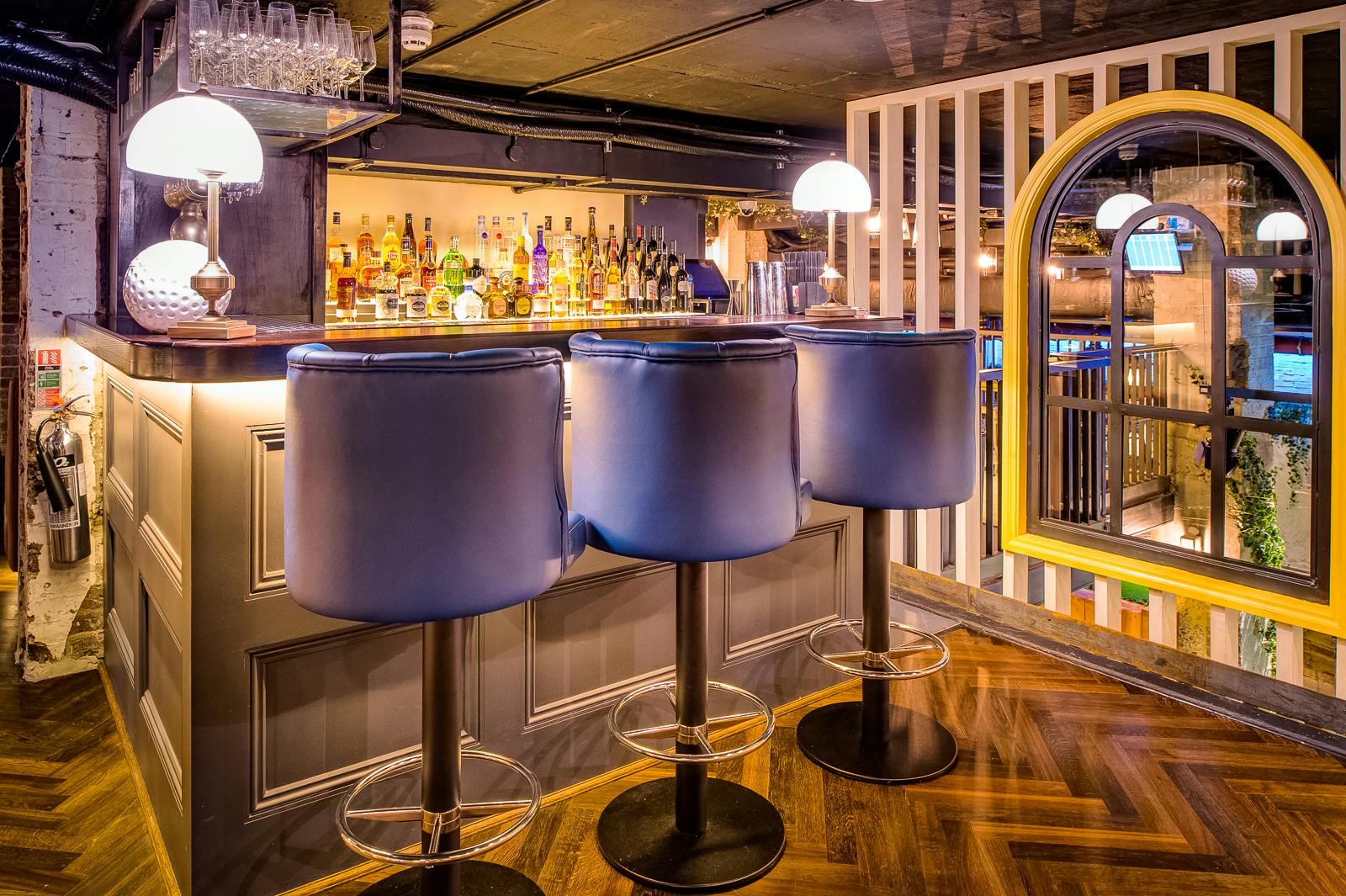 Stylish bar area in The Upper Clubhouse, perfect for networking events and gatherings.