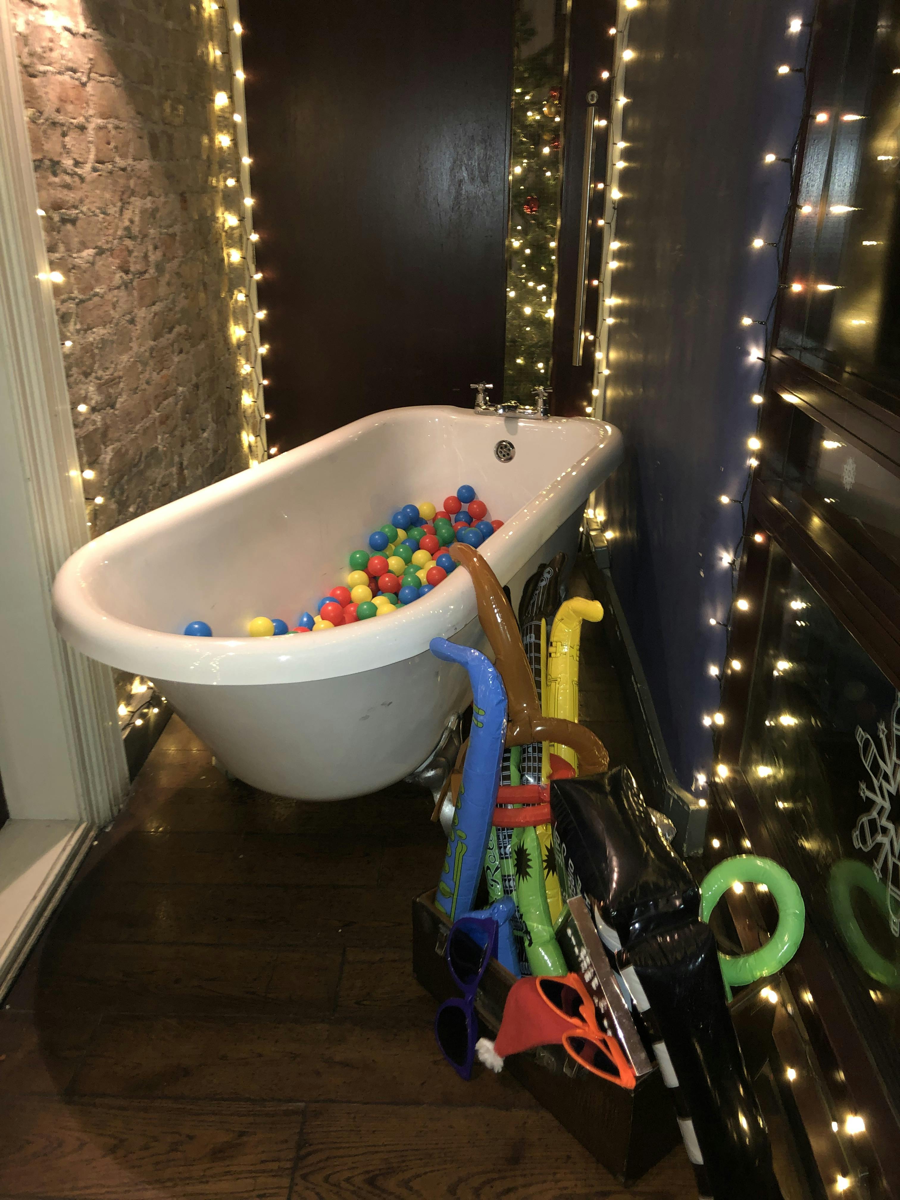 Vintage bathtub filled with colorful balls at The Loft, perfect for casual events in Manchester.