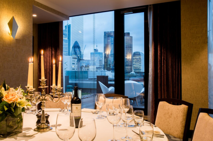 Elegant dining table with candlelight in Palm Rooms, perfect for upscale corporate events. - Banner