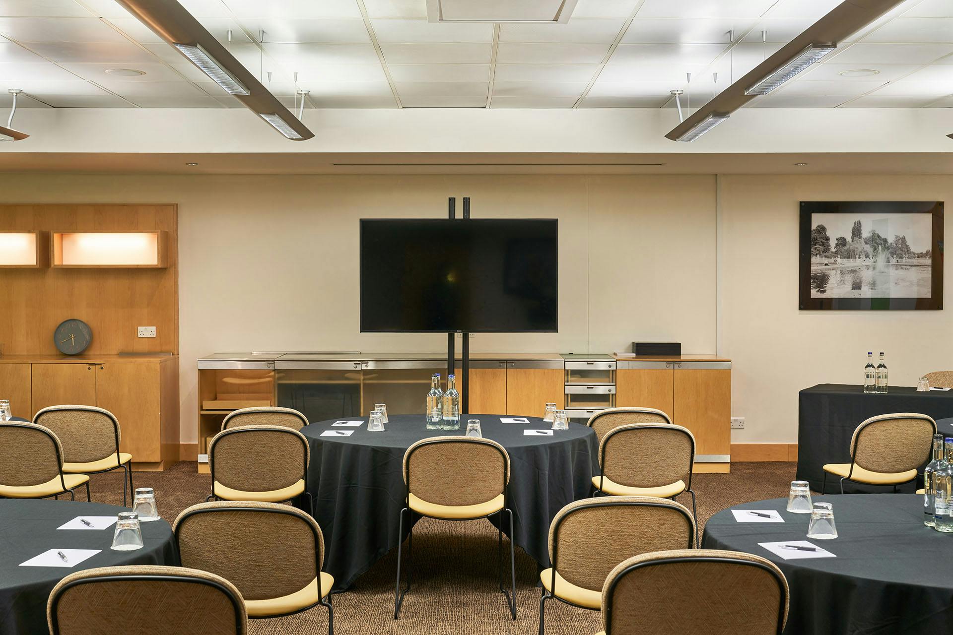 Meeting room at The Cumberland Hotel with circular tables for professional events.