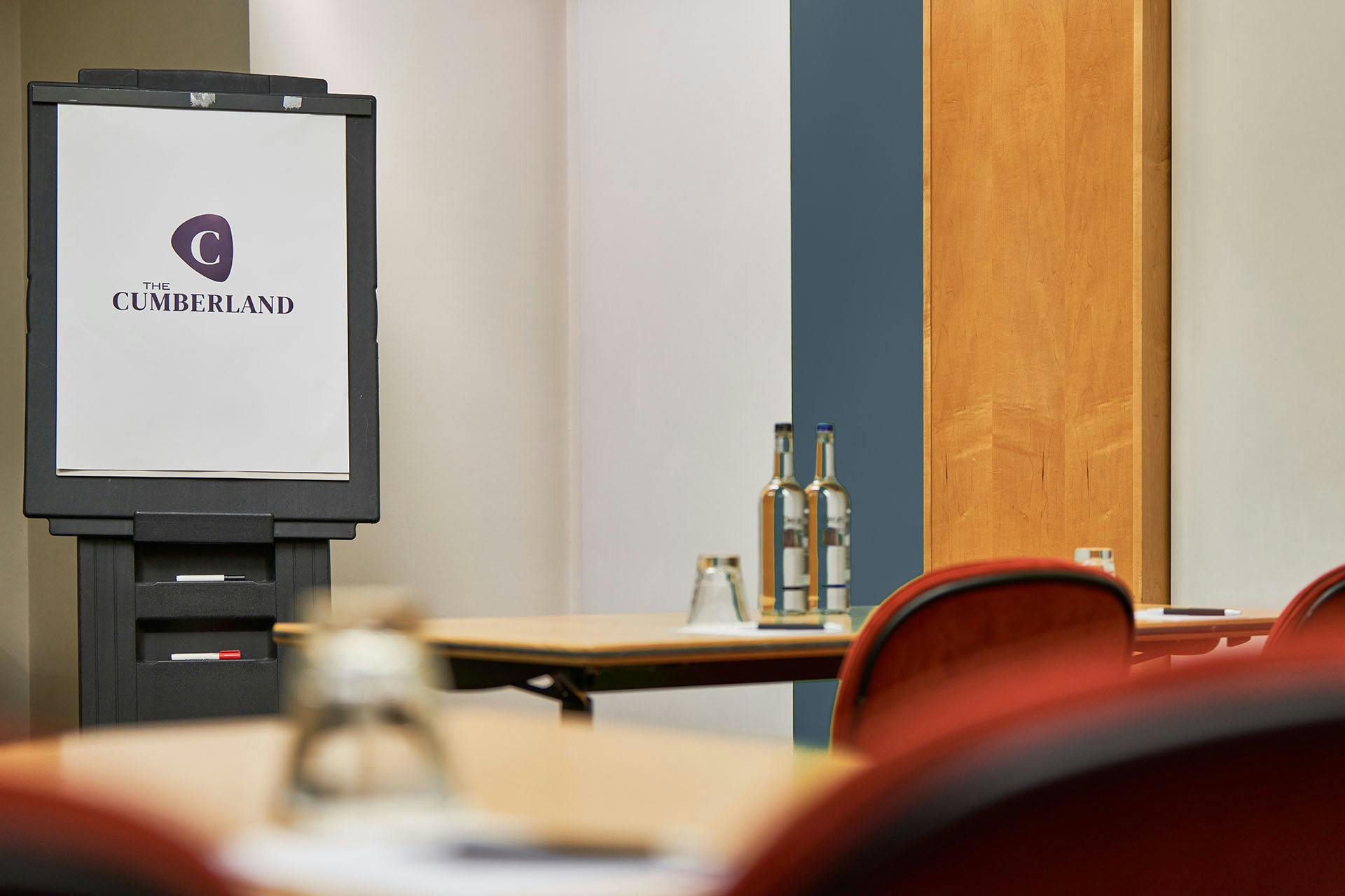 "Studio 8 meeting space at The Cumberland Hotel with branded board and organized tables."